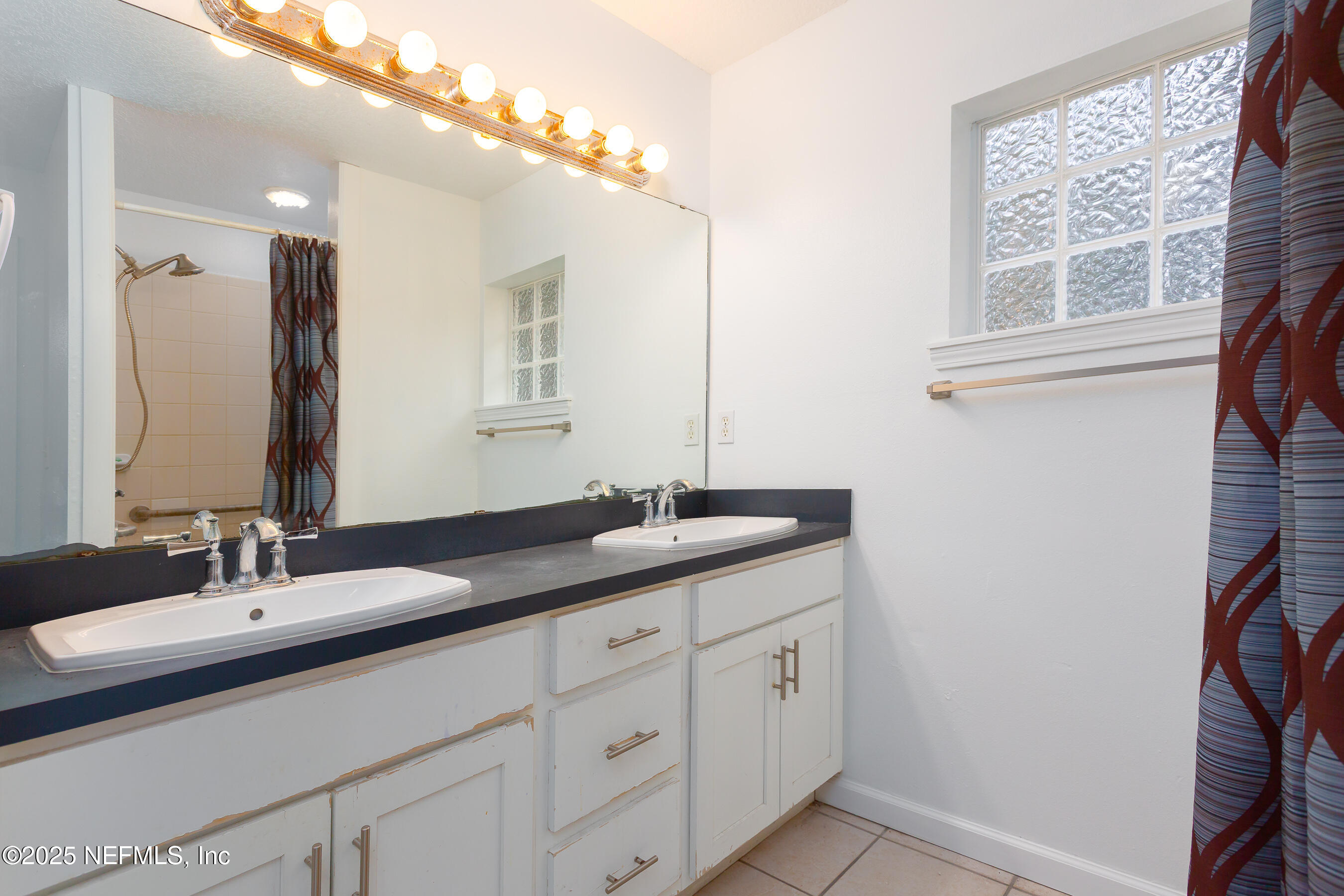 164 Carole Road Palatka, FL 32177 - Photo 9 of 32 a bathroom with a double vanity sink and a mirror