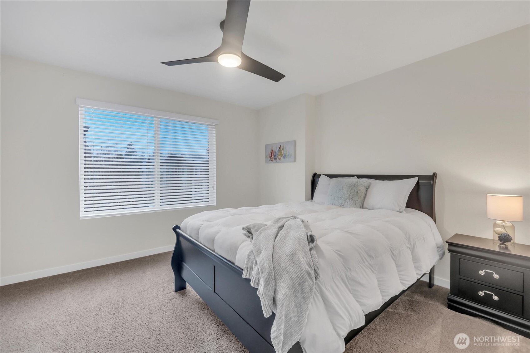 2010 129th Place Southwest, Unit E Everett, WA 98204 - Photo 24 of 37 a spacious bedroom with a bed and a chandelier