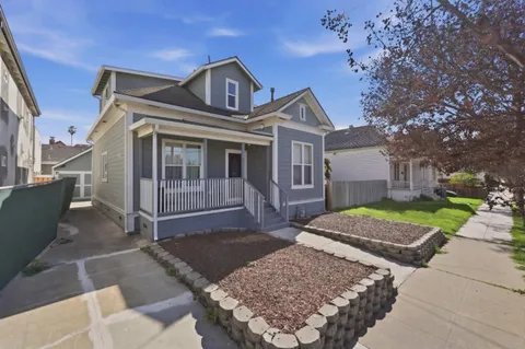 a front view of a house with garden