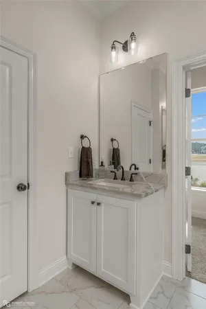 a bathroom with a double vanity sink and a mirror