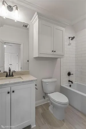 a bathroom with a granite countertop toilet a sink and a bathtub
