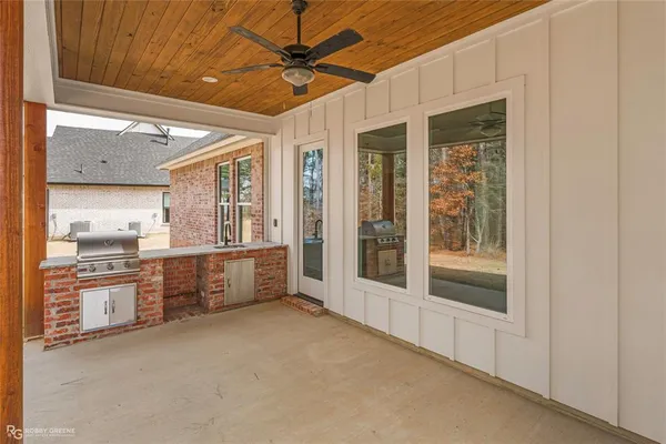 a large white kitchen with granite countertop a large window and a sink