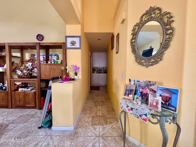 a living room with furniture and a mirror