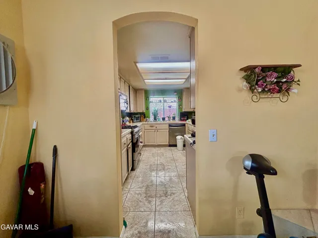 a view of a hallway with a livingroom and furniture
