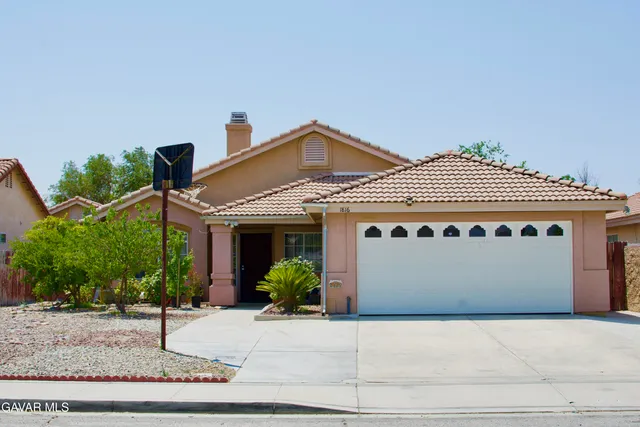 a front view of a house with garage
