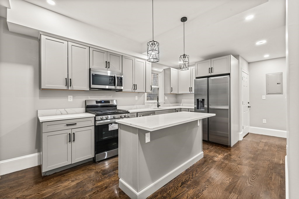 1 Claymont Terrace Boston, MA 02122 - Photo 12 of 42 a kitchen with stainless steel appliances granite countertop a refrigerator a stove a sink and a oven