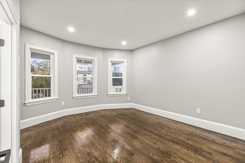 1 Claymont Terrace Boston, MA 02122 - Photo 14 of 42 a view of empty room with wooden floor and fan
