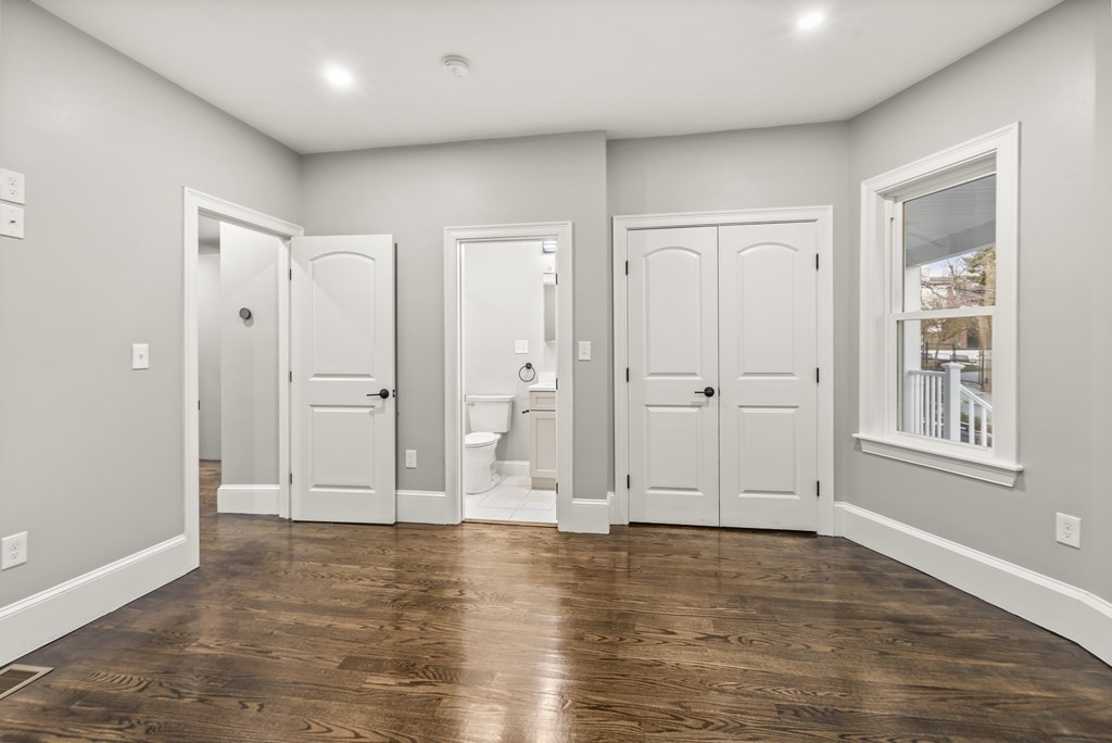 1 Claymont Terrace Boston, MA 02122 - Photo 15 of 42 an empty room with wooden floor and windows