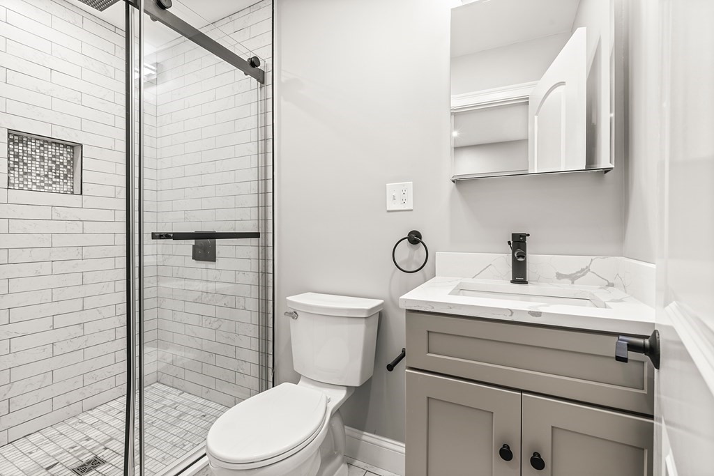 1 Claymont Terrace Boston, MA 02122 - Photo 16 of 42 a bathroom with a sink a toilet and shower