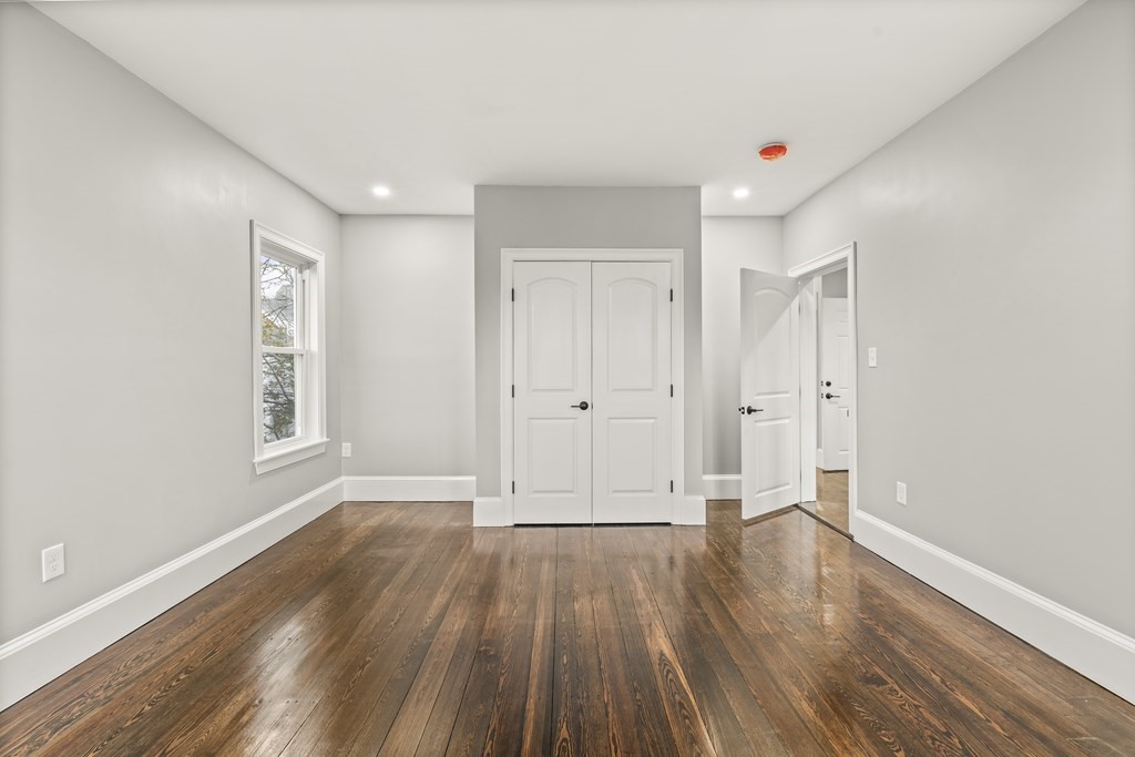1 Claymont Terrace Boston, MA 02122 - Photo 22 of 42 a view of empty room with wooden floor and window