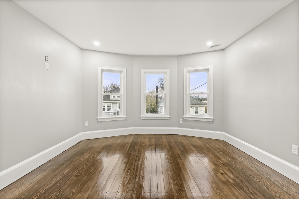1 Claymont Terrace Boston, MA 02122 - Photo 23 of 42 a view of empty room with wooden floor and fan