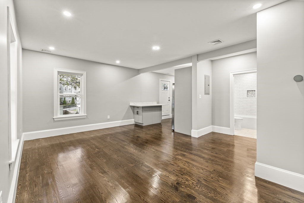1 Claymont Terrace Boston, MA 02122 - Photo 24 of 42 a view of an empty room with wooden floor and a window