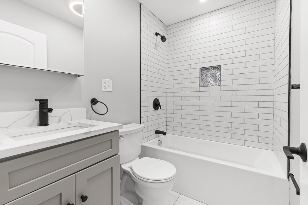 1 Claymont Terrace Boston, MA 02122 - Photo 25 of 42 a bathroom with a sink a toilet and a bathtub