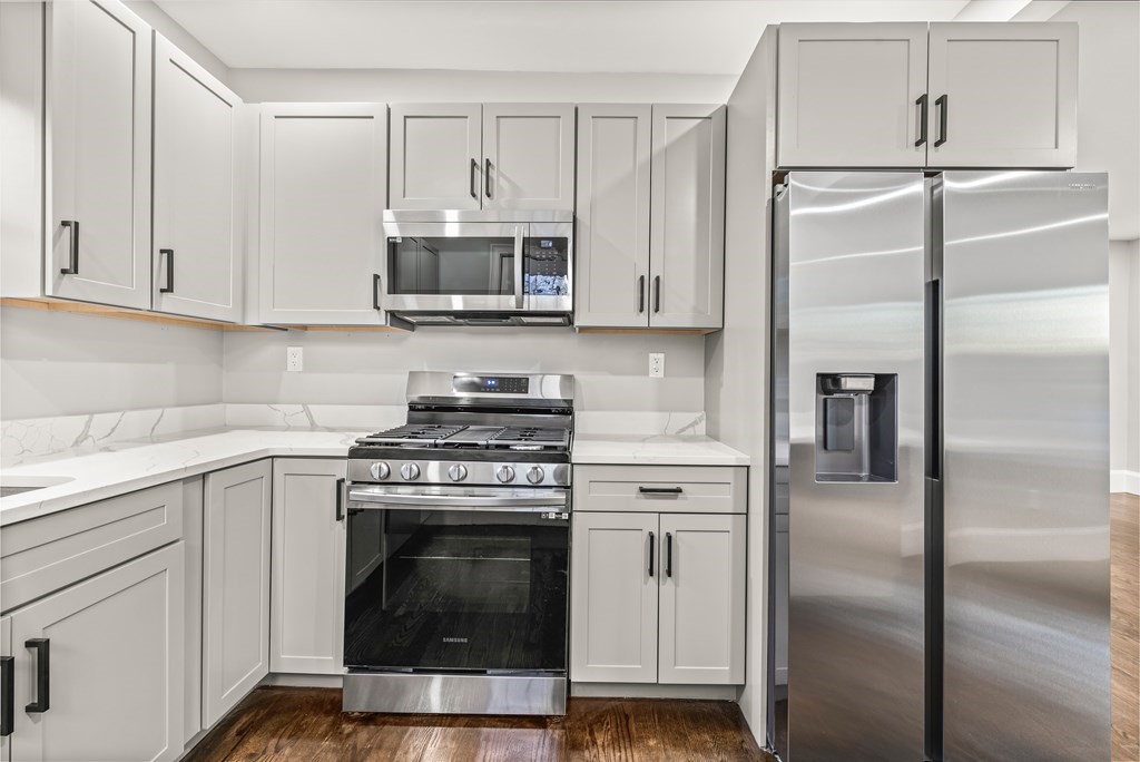 1 Claymont Terrace Boston, MA 02122 - Photo 28 of 42 a kitchen with cabinets stainless steel appliances and a counter space