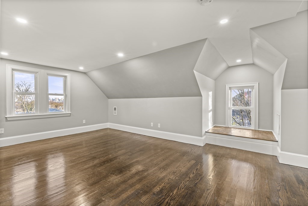 1 Claymont Terrace Boston, MA 02122 - Photo 30 of 42 an empty room with wooden floor and windows