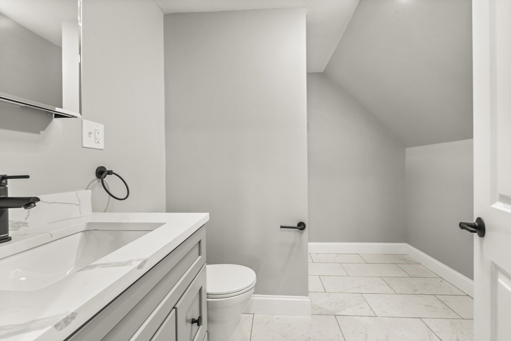 1 Claymont Terrace Boston, MA 02122 - Photo 36 of 42 a bathroom with a sink a toilet and shower