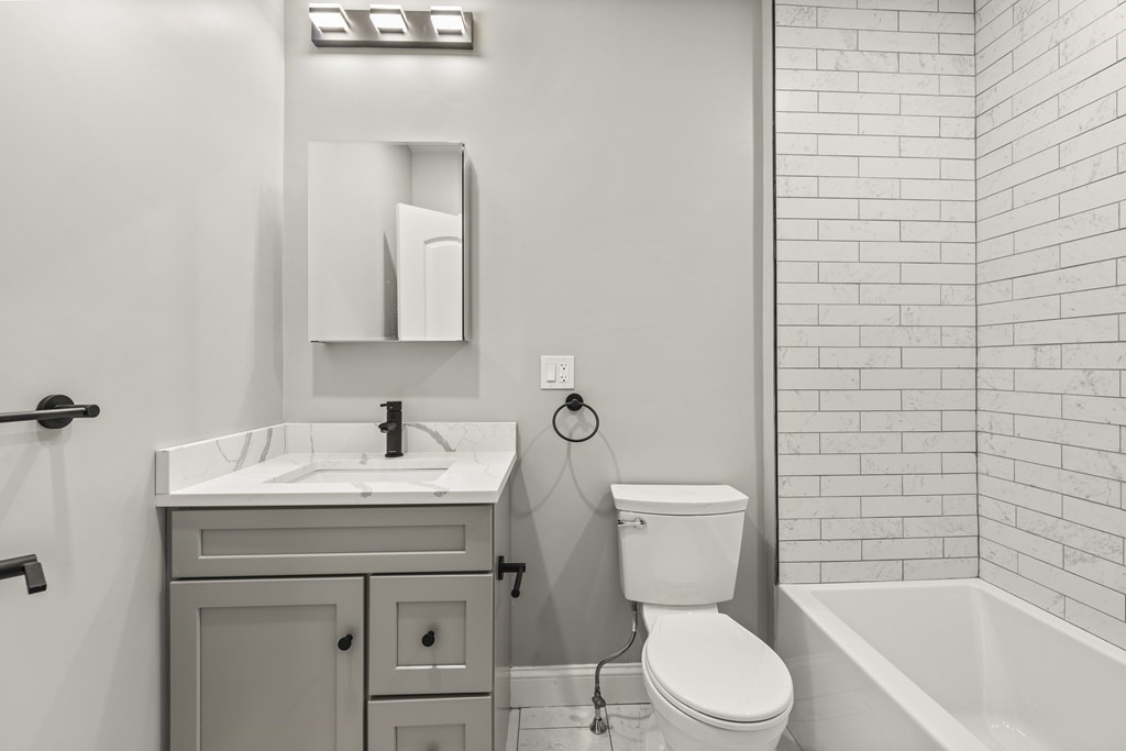 1 Claymont Terrace Boston, MA 02122 - Photo 41 of 42 a bathroom with a sink toilet vanity and tub