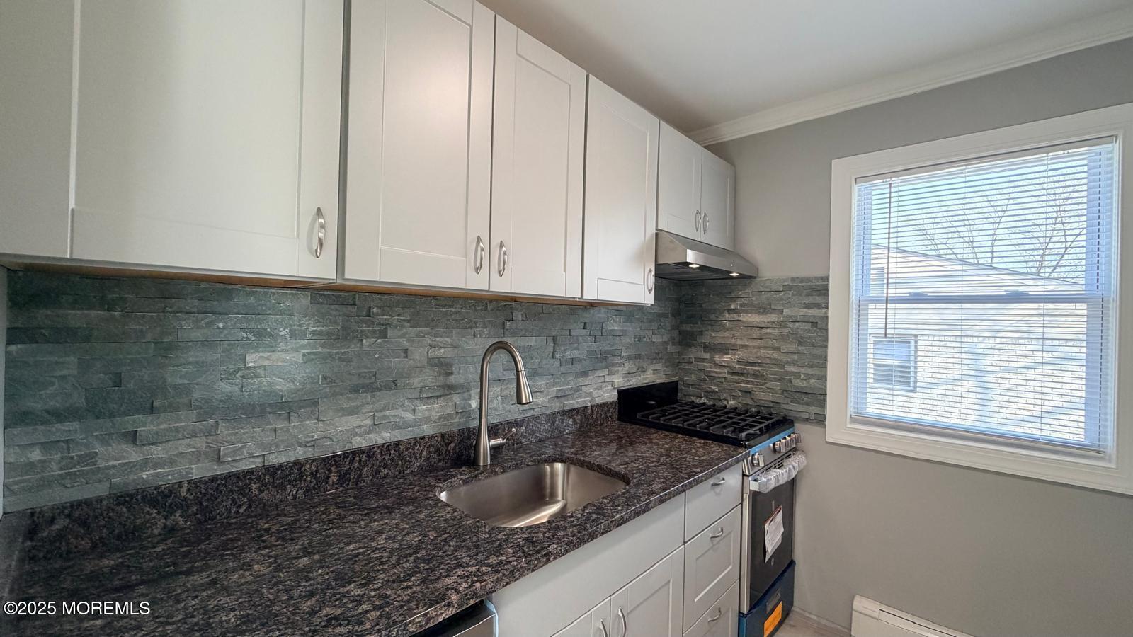 420 Cross Road, Unit B16 Matawan, NJ 07747 - Photo 13 of 36 a kitchen with granite countertop a sink and cabinets