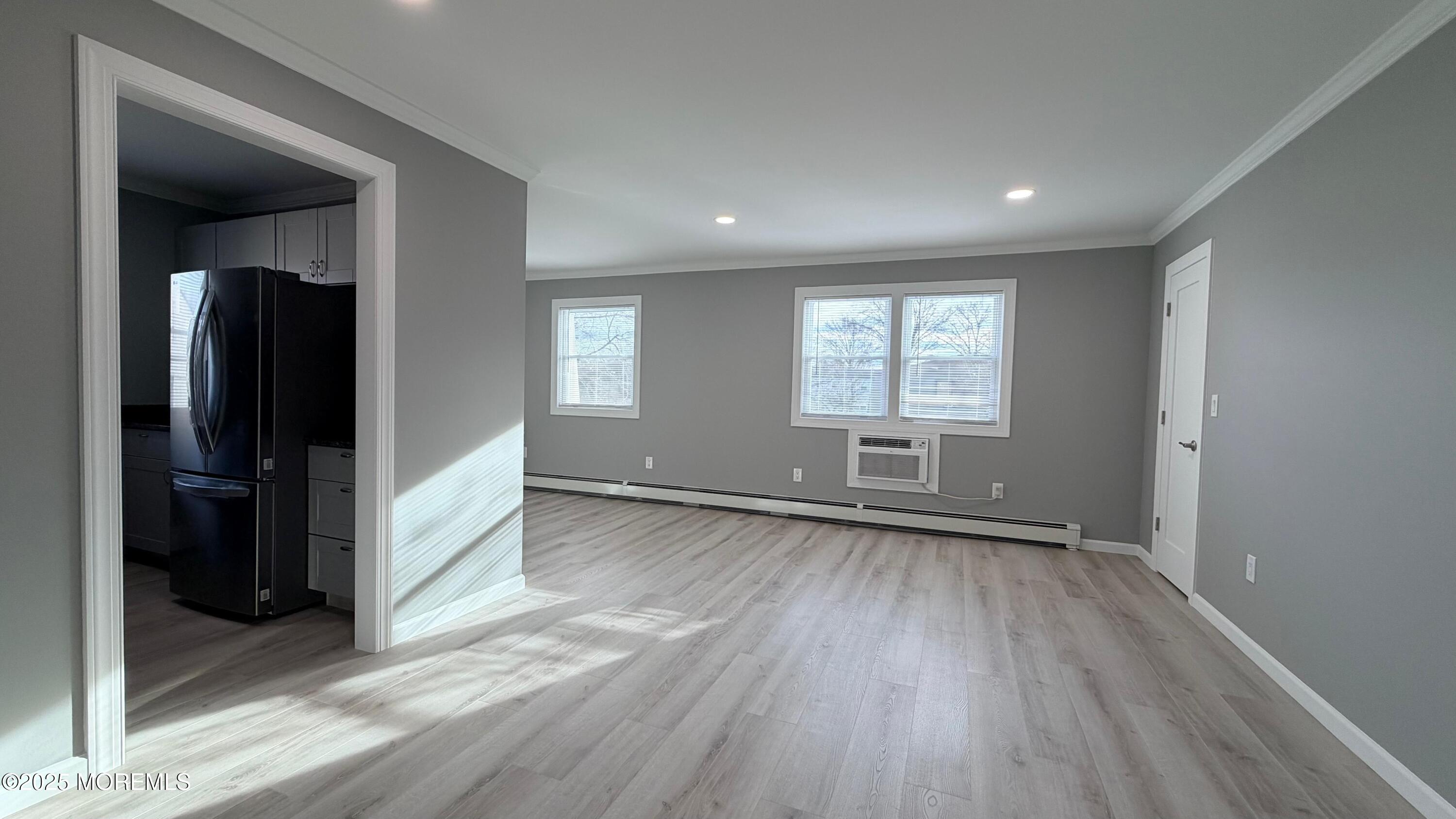 420 Cross Road, Unit B16 Matawan, NJ 07747 - Photo 15 of 36 an empty room with wooden floor and a window