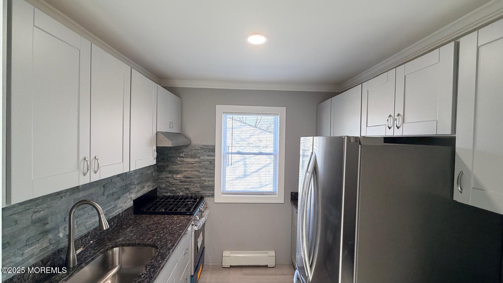 420 Cross Road, Unit B16 Matawan, NJ 07747 - Photo 17 of 36 a kitchen with stainless steel appliances granite countertop a refrigerator and a sink