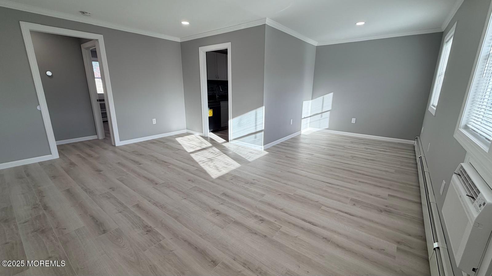 420 Cross Road, Unit B16 Matawan, NJ 07747 - Photo 19 of 29 a view of an empty room with wooden floor and a window