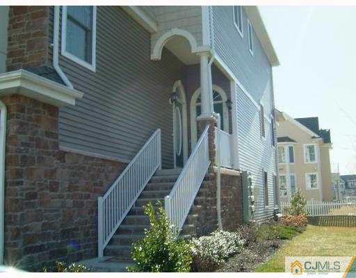 49 Raritan Reach Road South Amboy, NJ 08879 - Photo 1 of 10 a view of a brick house with a large windows stairs and potted plants