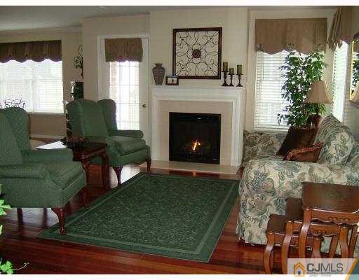 49 Raritan Reach Road South Amboy, NJ 08879 - Photo 3 of 10 a living room with furniture and a fireplace