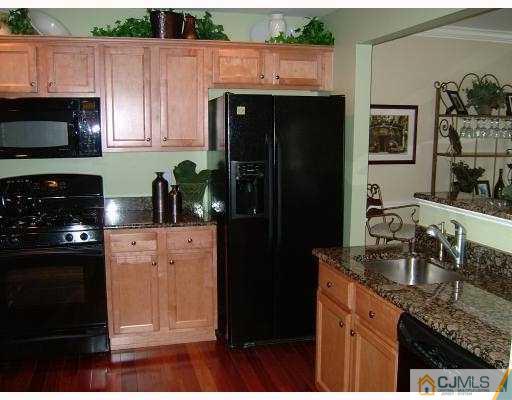 49 Raritan Reach Road South Amboy, NJ 08879 - Photo 5 of 10 a kitchen with granite countertop a refrigerator stove and microwave