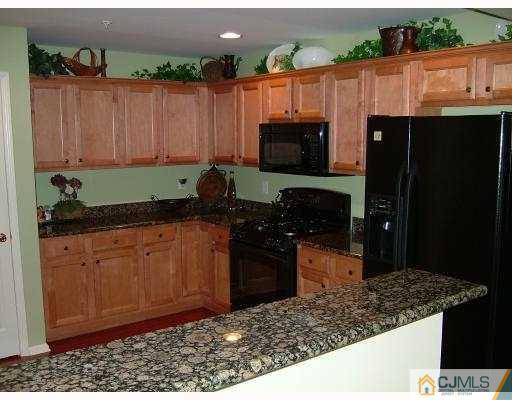 49 Raritan Reach Road South Amboy, NJ 08879 - Photo 6 of 10 a kitchen with stainless steel appliances granite countertop a refrigerator and a stove top oven