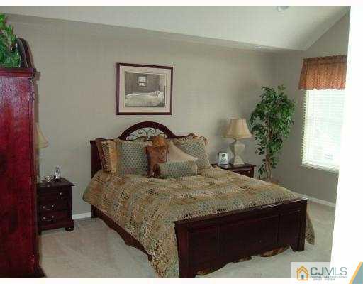 49 Raritan Reach Road South Amboy, NJ 08879 - Photo 8 of 10 a bedroom with a bed and a potted plant
