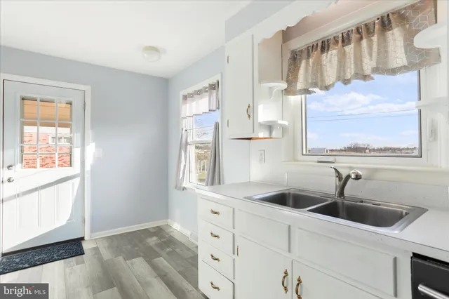 a kitchen with stainless steel appliances a sink and a window