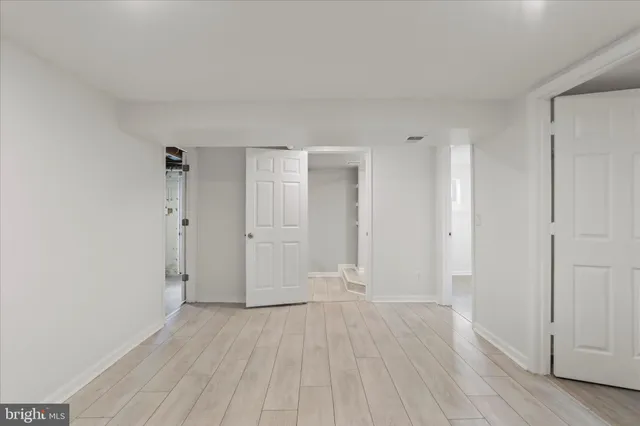 an empty room with wooden floor