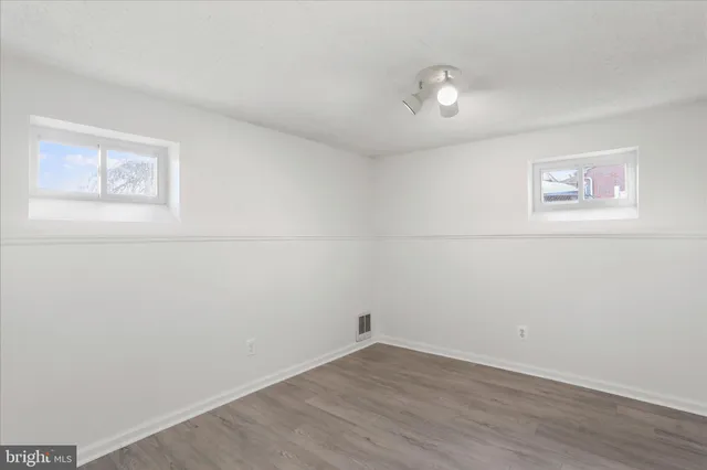 a view of a room with wooden floor