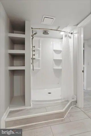 a bathroom with a glass shower door
