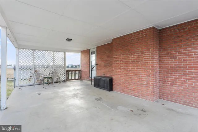 a view of an empty room with a fireplace