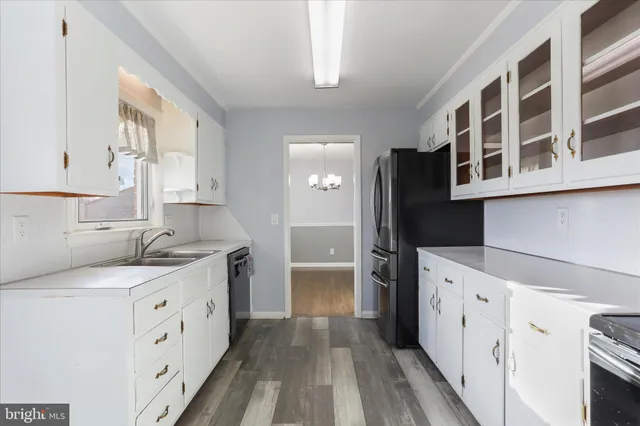 a kitchen with cabinets and window