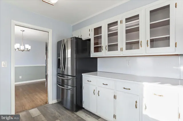 a kitchen with stainless steel appliances wooden cabinet and a refrigerator