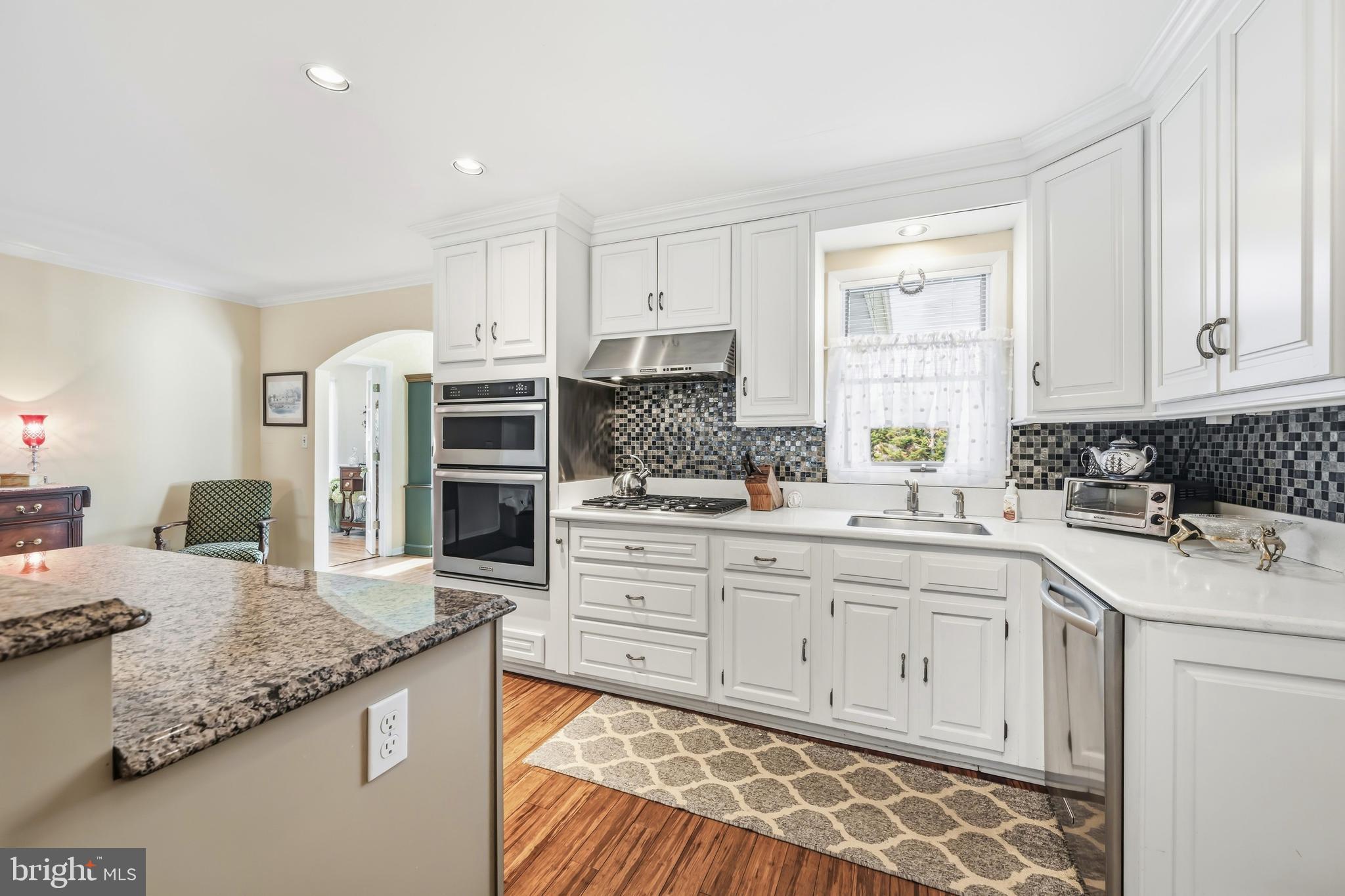 24561 Deepwater Point Drive St. Michaels, MD 21663 - Photo 19 of 50 a kitchen with stainless steel appliances granite countertop a sink and cabinets