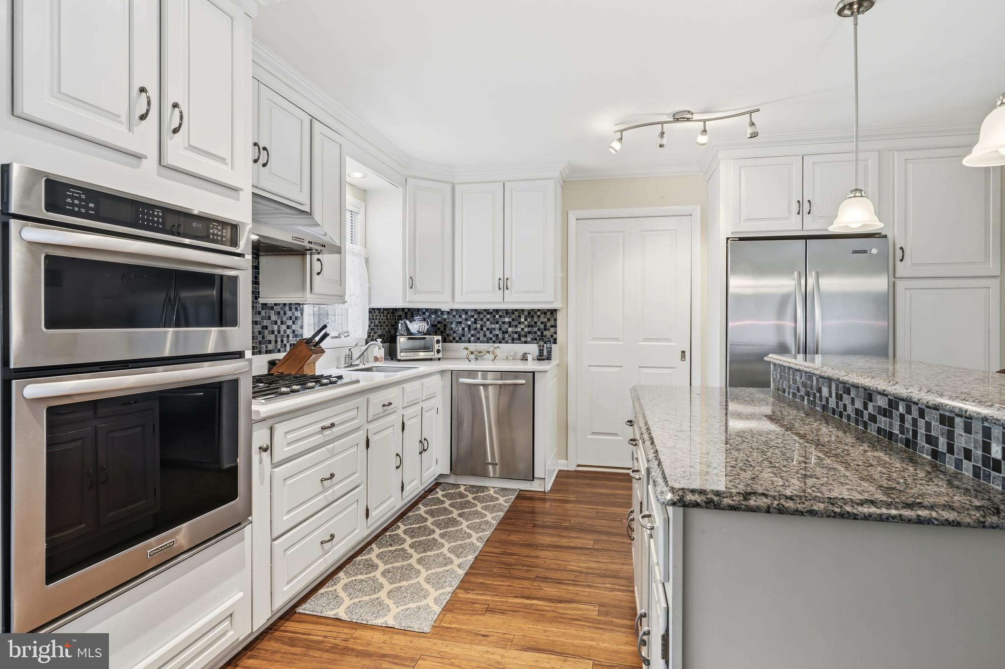 24561 Deepwater Point Drive St. Michaels, MD 21663 - Photo 20 of 50 a kitchen with granite countertop a sink stove and refrigerator