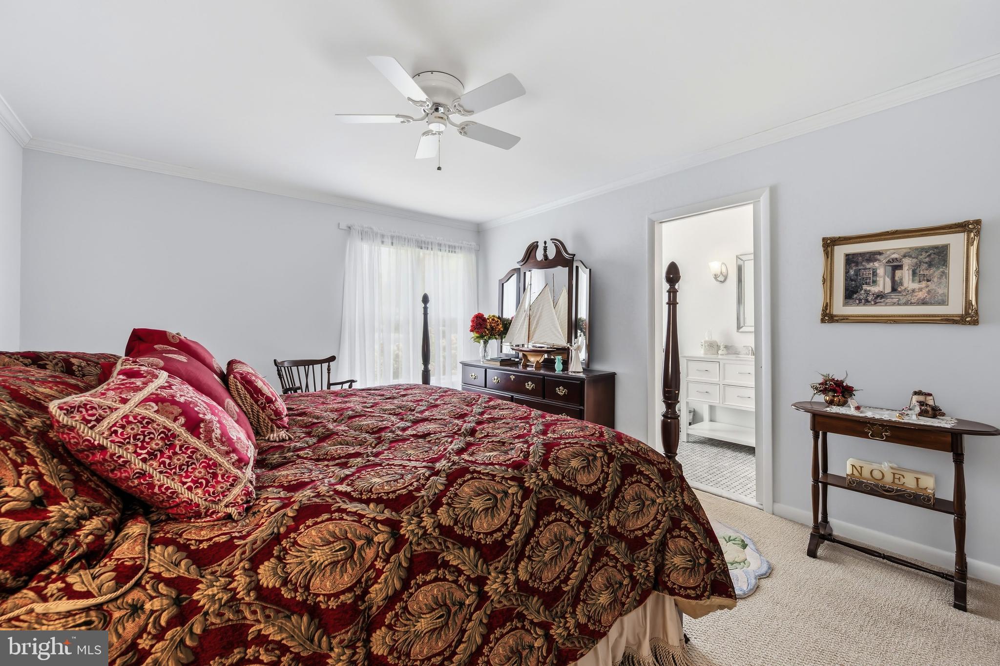 24561 Deepwater Point Drive St. Michaels, MD 21663 - Photo 31 of 50 a bedroom with a bed and a chandelier