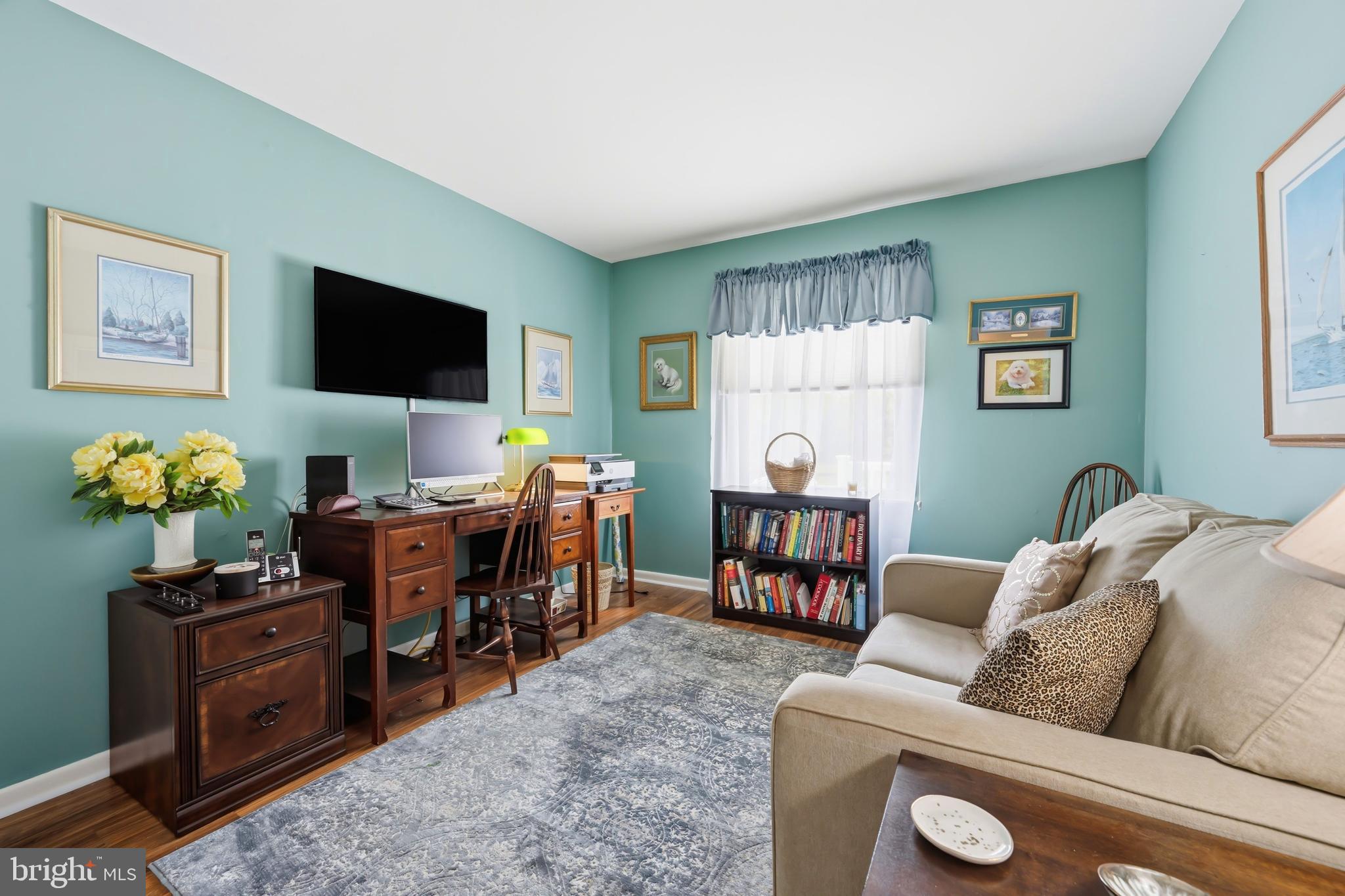 24561 Deepwater Point Drive St. Michaels, MD 21663 - Photo 38 of 50 a living room with furniture a computer on the desk and a flat screen tv