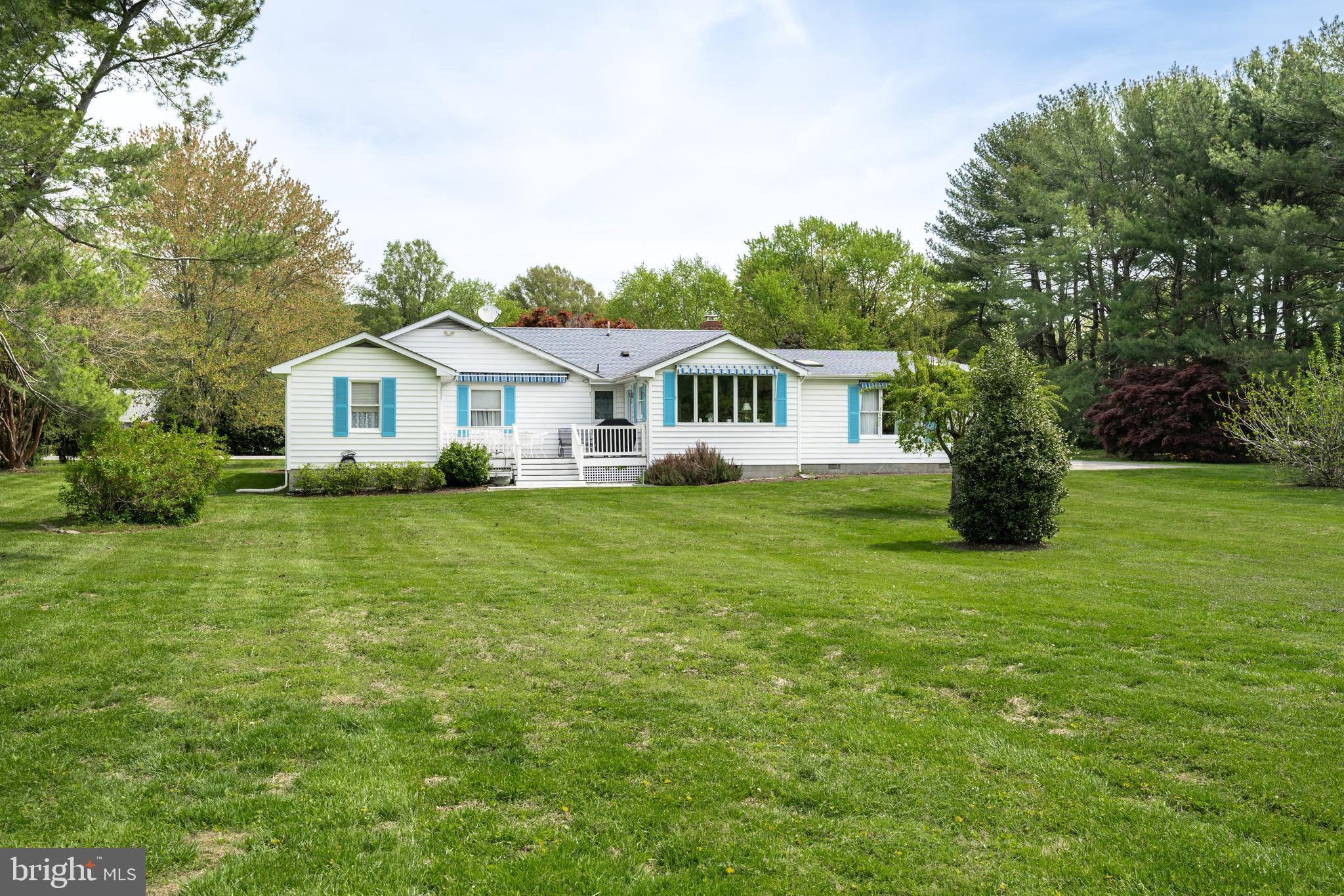 24561 Deepwater Point Drive St. Michaels, MD 21663 - Photo 5 of 50 a front view of a house with a garden