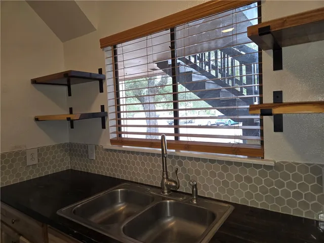 a kitchen with a sink and cabinets