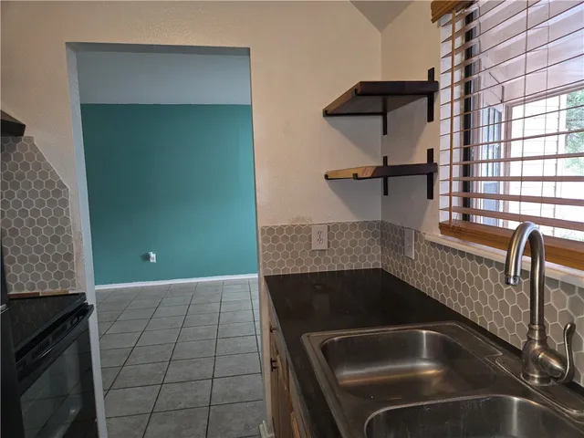 a kitchen with a sink and cabinets