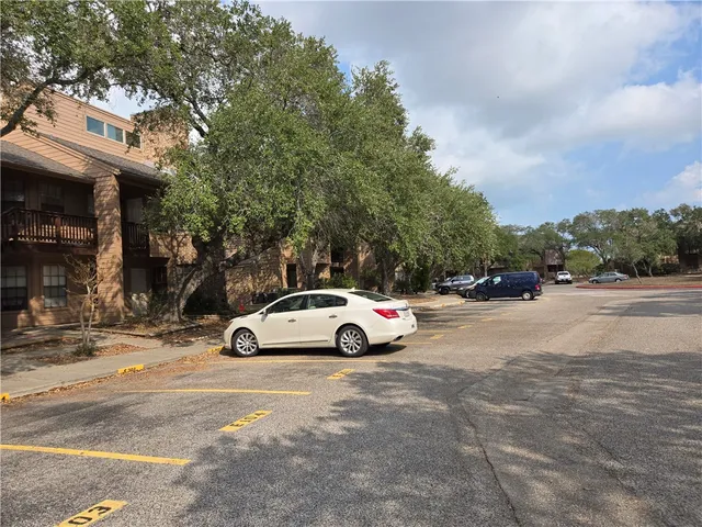 a view of street with parked cars