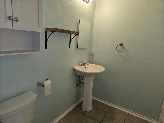 a bathroom with a sink toilet and a mirror