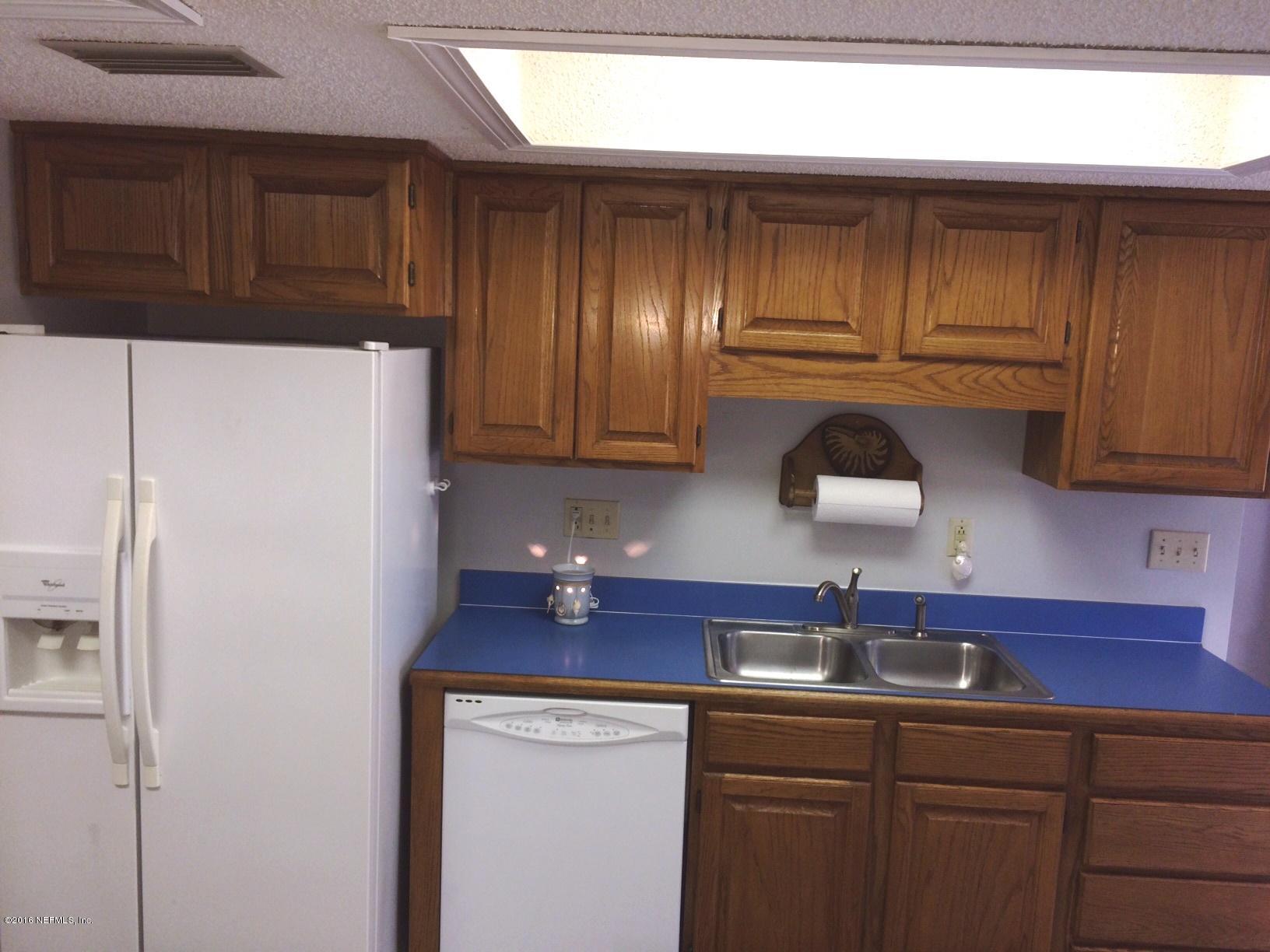 1112 Cactus Cut Road Middleburg, FL 32068 - Photo 11 of 48 a kitchen with stainless steel appliances a refrigerator and cabinets