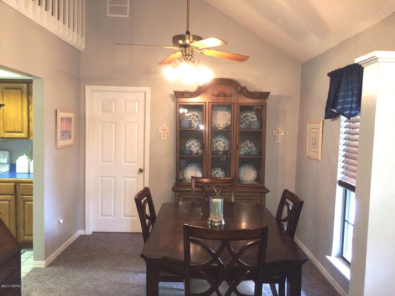 1112 Cactus Cut Road Middleburg, FL 32068 - Photo 12 of 48 a view of a dining room with furniture and chandelier