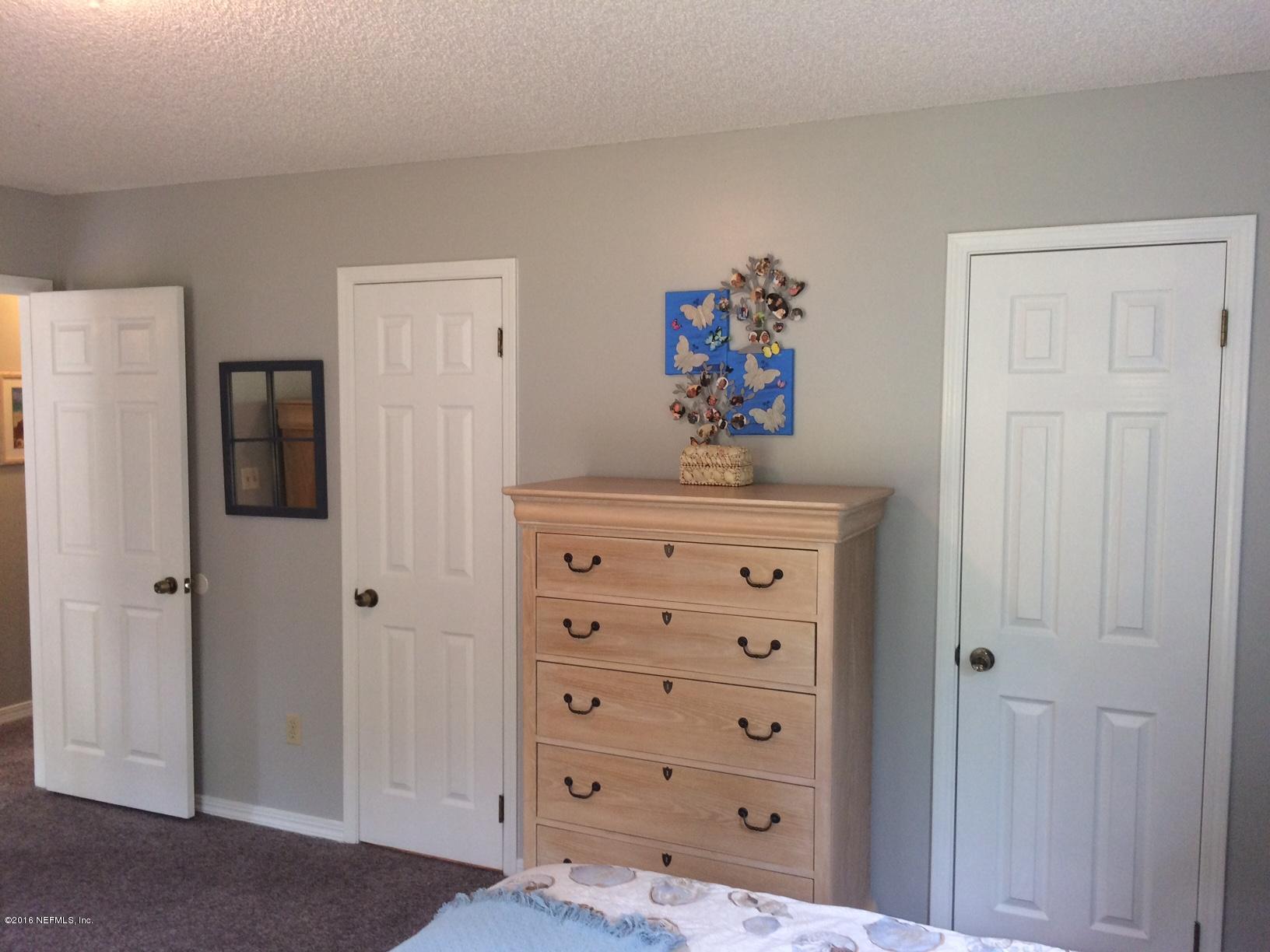 1112 Cactus Cut Road Middleburg, FL 32068 - Photo 17 of 48 a view of a hallway with painting on the wall