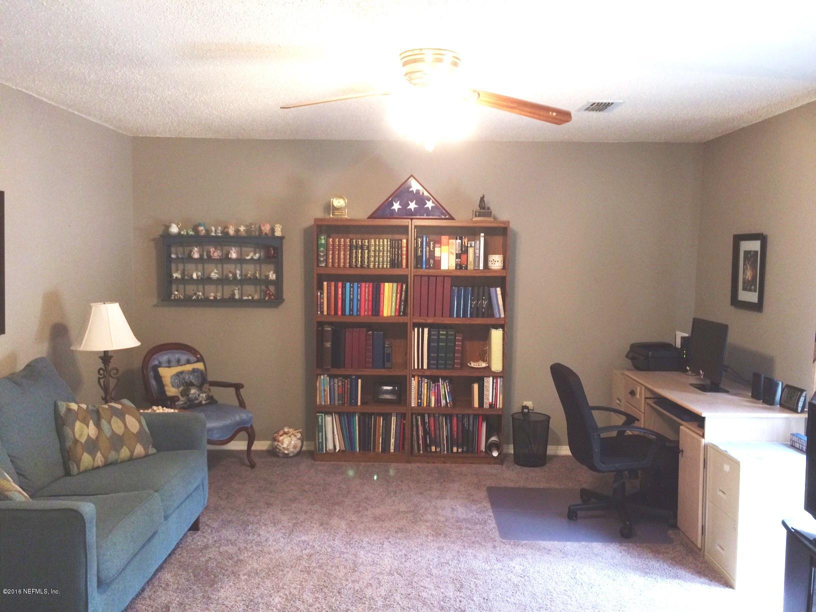 1112 Cactus Cut Road Middleburg, FL 32068 - Photo 20 of 48 a view of a workspace with furniture and a bookshelf
